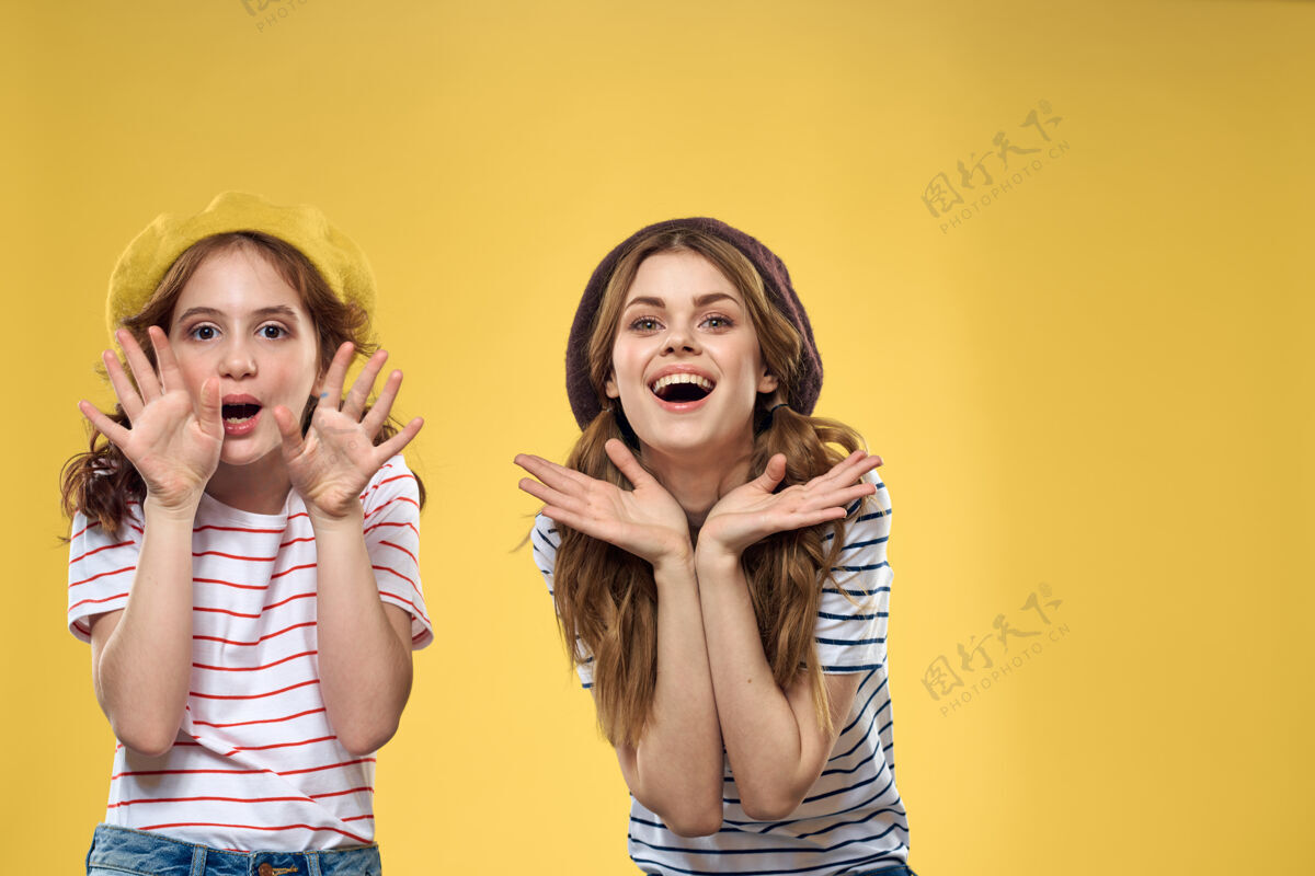 脸妈妈和女儿拥抱欢乐快乐童年生活方式黄色背景快乐时尚拥抱
