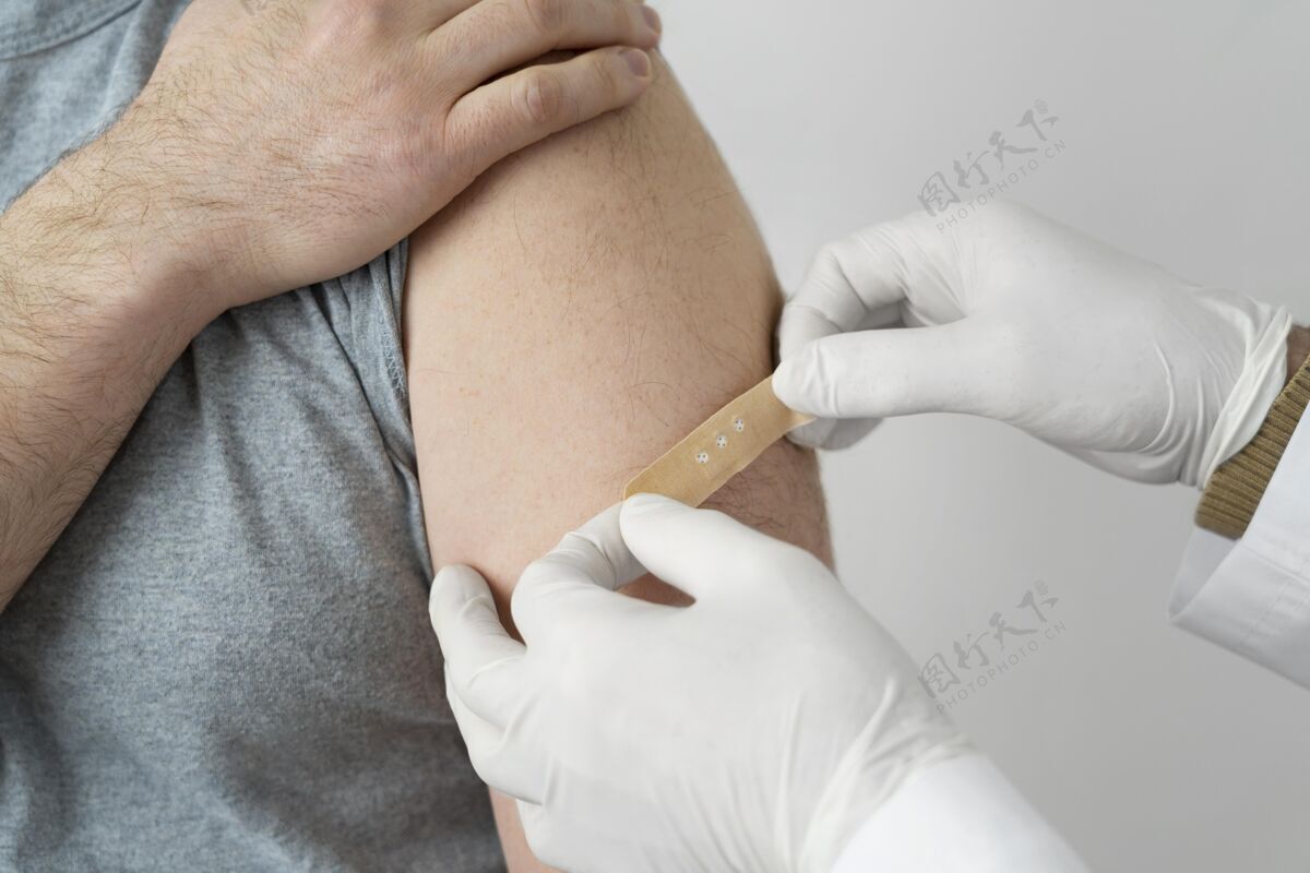 药品注射疫苗后 医生在男病人手臂上缠绷带注射疫苗防护