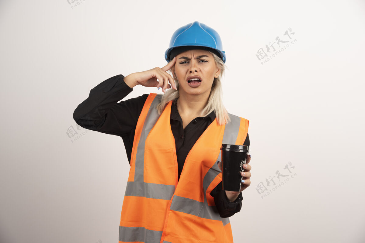 杯子女工喝着茶头痛高质量照片职业头盔工人