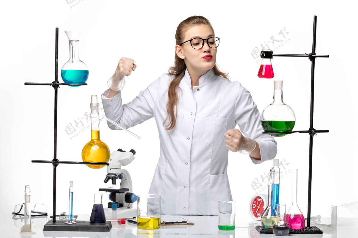 女化学家前视图穿着医疗服的女化学家在一张白色办公桌上摆姿势化学病毒大流行covid-化学诊所桌子