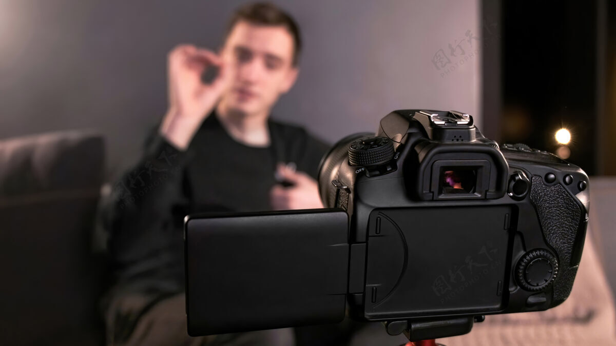 互联网年轻的内容创作者用三脚架上的相机拍摄自己的照片技术男人年轻人