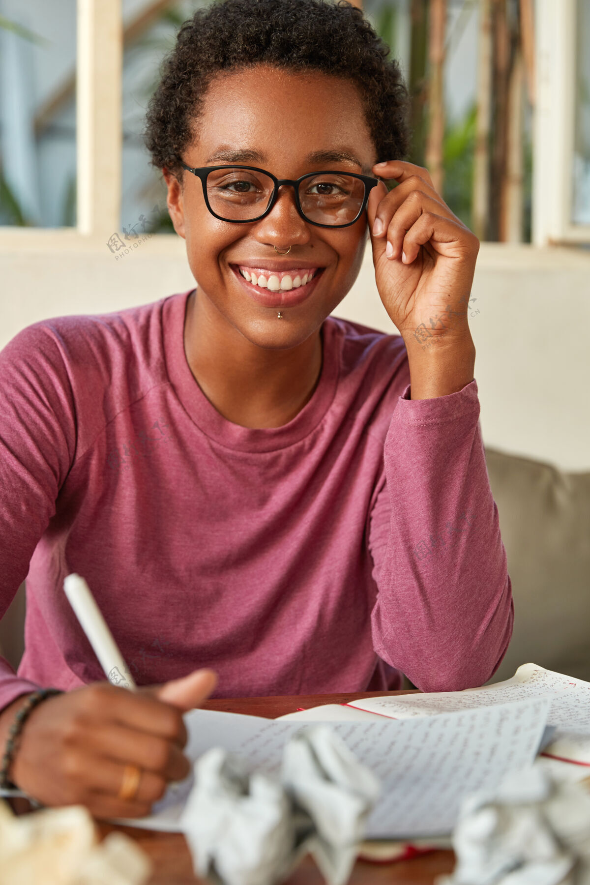 博客开朗的黑皮肤女士记笔记 在日历上创造提醒清单牙齿眼镜