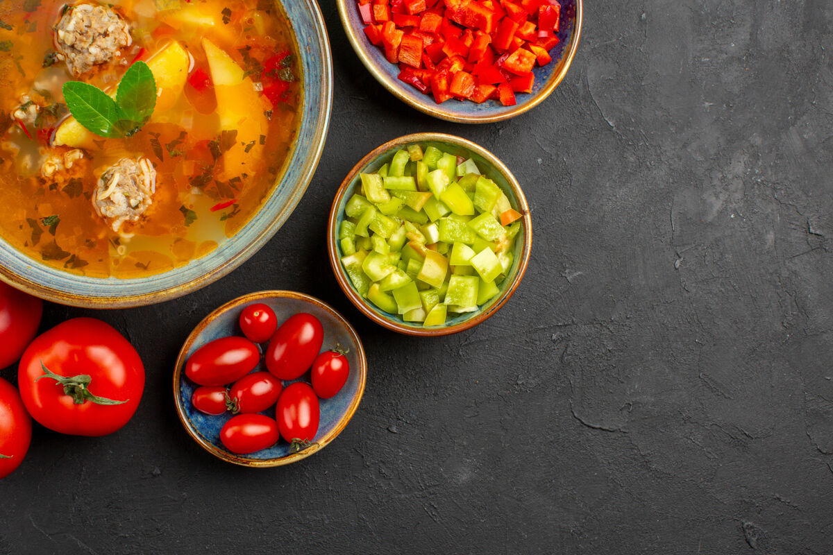 美食俯瞰美味的肉汤配上新鲜蔬菜上深色餐桌上的菜品照片美食蔬菜顶美味