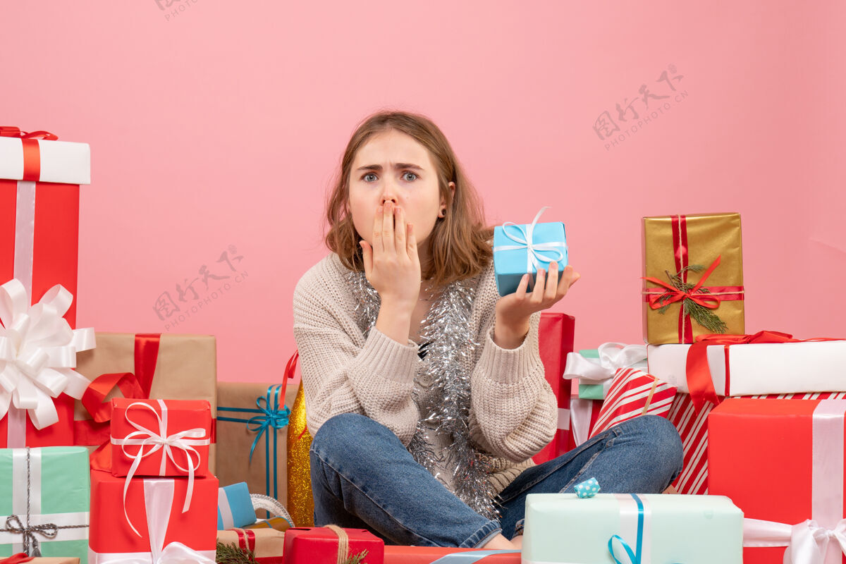 坐着正面图年轻女性围坐在不同的礼物旁边休闲圣诞节节日