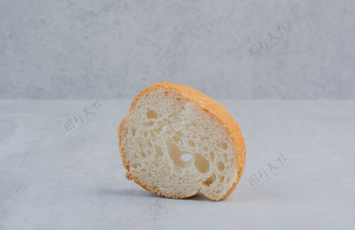 面包在大理石背景上放一片新鲜的圆形白面包烘焙糕点馒头