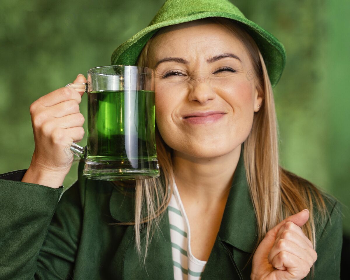 爱尔兰戴帽子的笑脸女人在酒吧喝酒庆祝圣帕特里克节庆祝女性爱尔兰