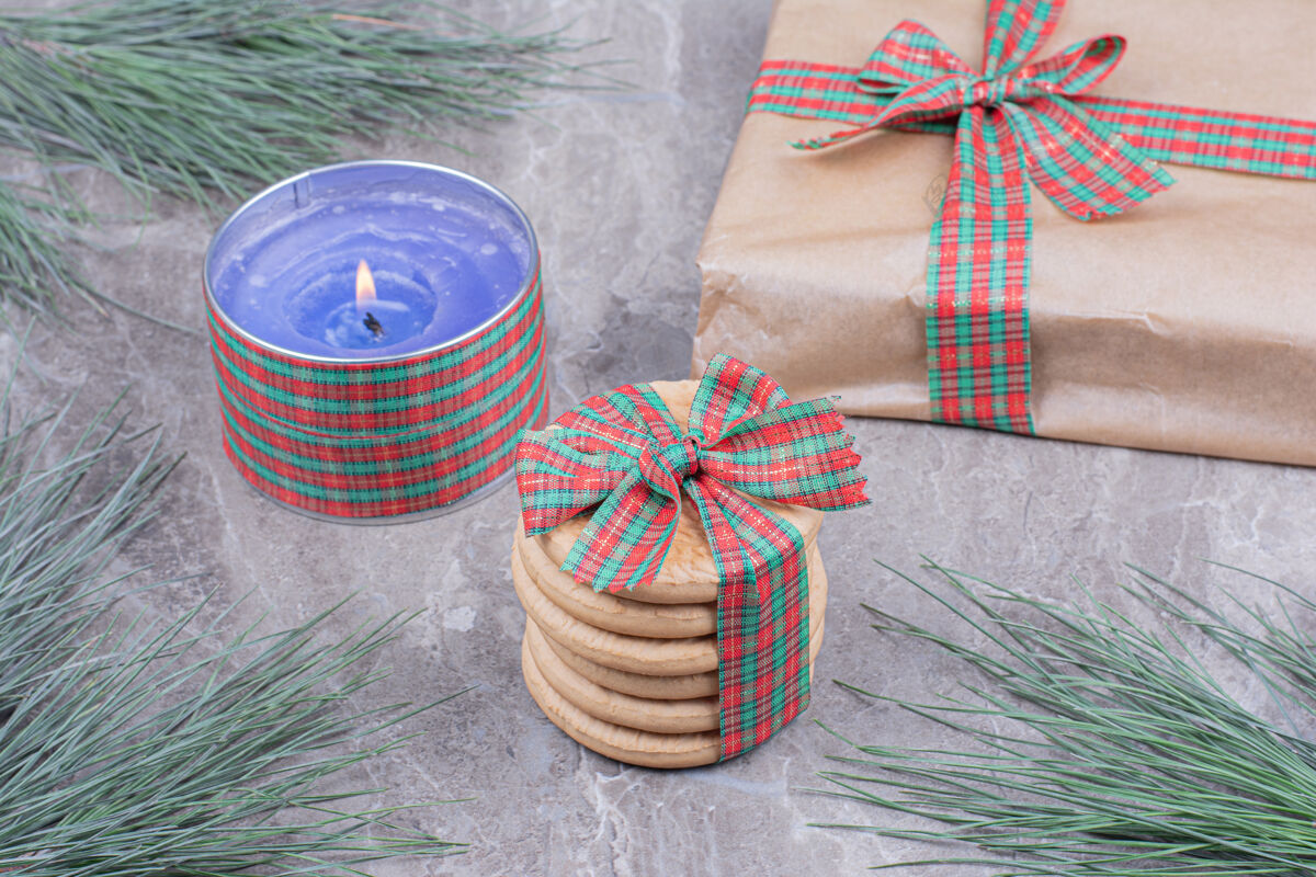 厨师用蓝色蜡烛和礼品盒包装的饼干零食地壳糕点