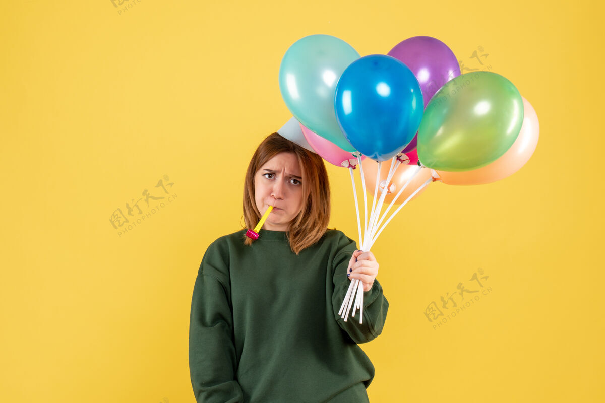 情感正面图是一位年轻的女士 手里拿着五颜六色的气球乐趣颜色多彩