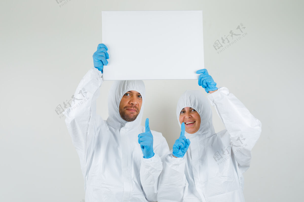诊所两个穿着防护服指着空白帆布的医生医生护理医学
