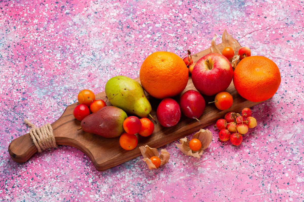 橘子顶视图不同的水果组成新鲜和醇厚的水果粉红色背景健康成分柑橘